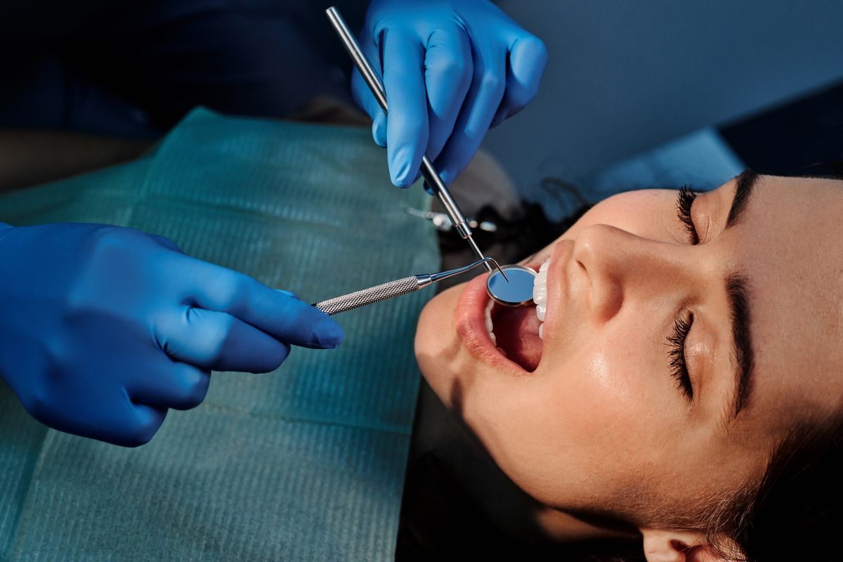 Dentist fitting a patient during a restorative visit